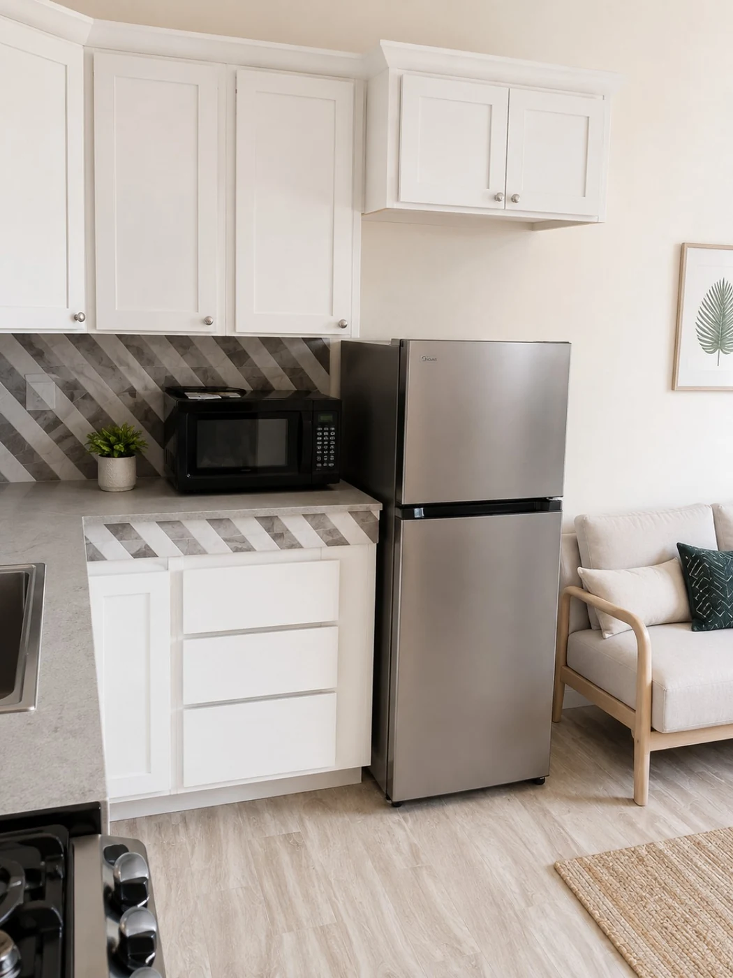 Kitchenette with refrigerator and sofa area